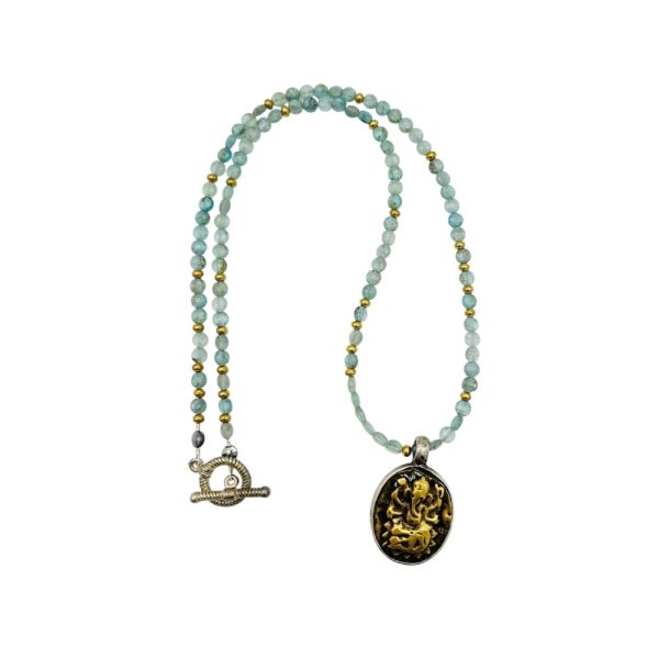 Gold and silver necklace with blue beads and a pendant.