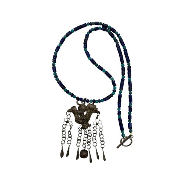 Blue beaded necklace with bird pendant.